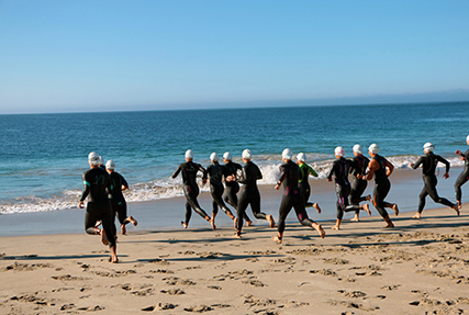 Athletes enter the Pacific Ocean at Point Mugu Beach for the start of the 2021 Armed Forces Triathlon Championship held on 11 September. Service members from the Marine Corps, Navy (with Coast Guard) personnel), and Air Force (with Space Force personnel) compete for gold. (Department of Defense Photo, Released)