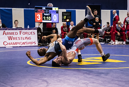 20022-N-XK513-1611 NAVAL BASE KITSAP, Wa. (Feb. 22, 2020) - Army Spc Alejandro Sancho (bottom) rolls his opponent during the Greco-Roman event during the final round of the 2020 Armed Forces Sports Wrestling Championship at the Bremeton Fitness Complex on Feb. 22. (U.S. Navy Photo by Mass Communication Specialist 1st Class Ian Carver/RELEASED).